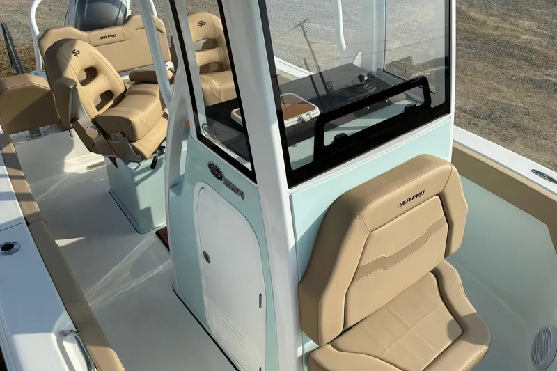 Slide: The Image of 2026 Sea Pro 245FLX Sandbar boat interior with tan seating and console. - 30