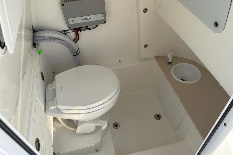 Slide: The Image of Interior of 2026 Sea Pro 245FLX Sandbar boat bathroom with toilet and sink. - 31