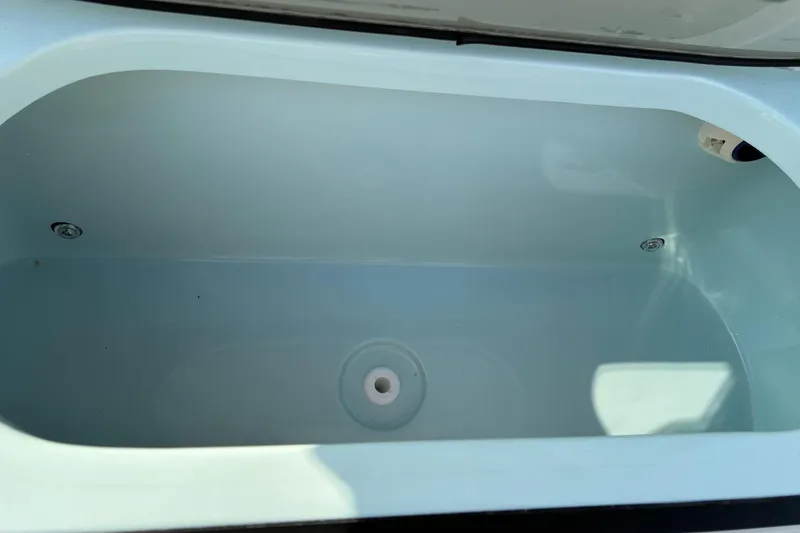 Slide: The Image of Livewell compartment of 2026 Sea Pro 245FLX Sandbar boat, empty and clean. - 37