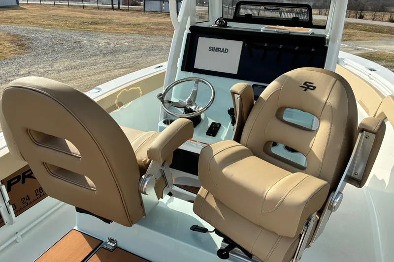 Slide: The Image of 2026 Sea Pro 245FLX Sandbar boat interior with beige seats and steering console. - 9
