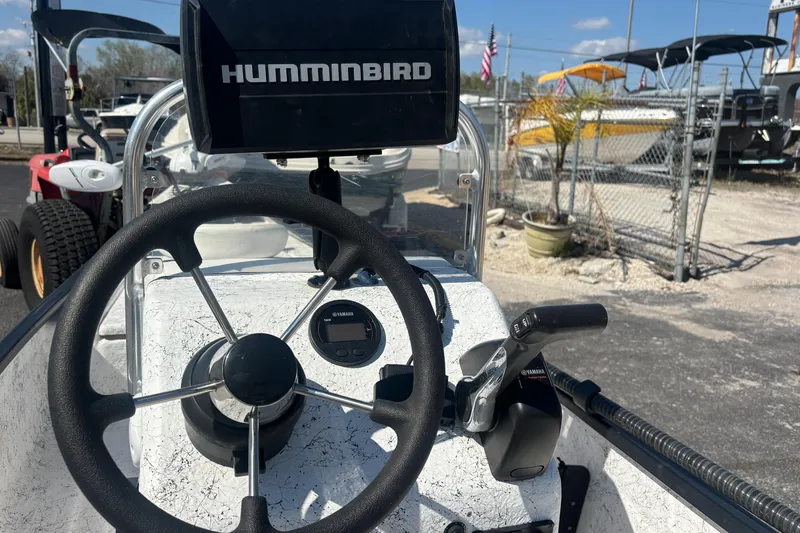 Slide: The Image of 2017 GHEENUE Super 16 boat dashboard with Humminbird system and Yamaha controls. - 18