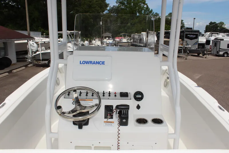 Slide: The Image of 2024 Clear Water 2200 CC boat console with steering wheel and controls. - 10