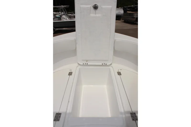 Slide: The Image of 2024 Clear Water 2200 CC boat storage compartment with open hatch, showcasing spacious interior. - 16