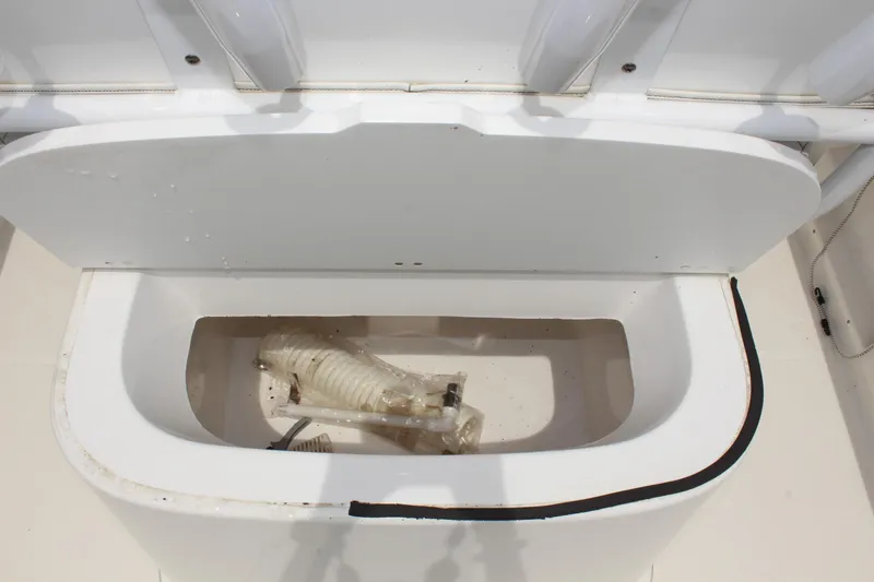 Slide: The Image of 2024 Clear Water 2200 CC boat storage compartment with hose inside. - 9