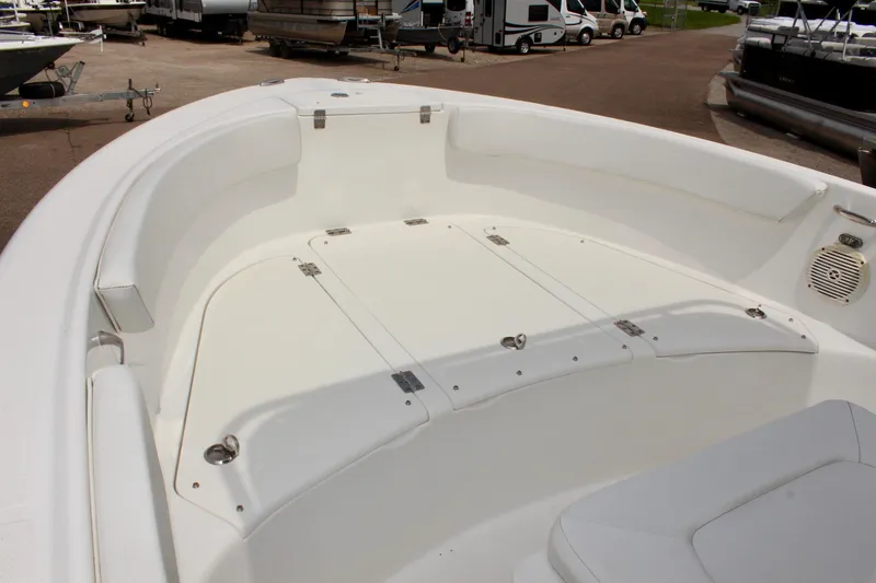 Slide: The Image of 2024 Clear Water 2200 CC boat interior with white seating and storage compartments. - 13