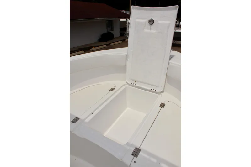 Slide: The Image of 2024 Clear Water 2200 CC boat storage compartment with open hatch, showcasing spacious interior. - 17
