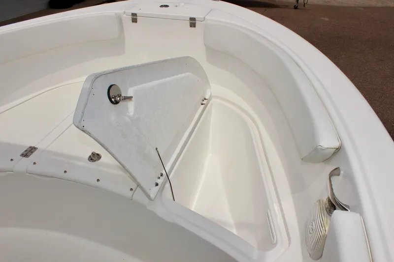 Slide: The Image of 2024 Clear Water 2200 CC boat interior with white seating and storage compartment. - 20