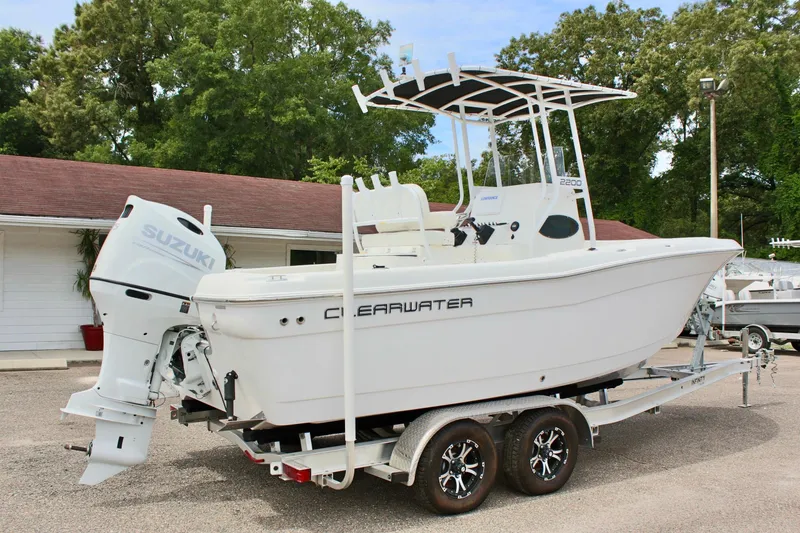 Slide: The Image of 2024 Clear Water 2200 CC boat on trailer with Suzuki outboard motor. - 6