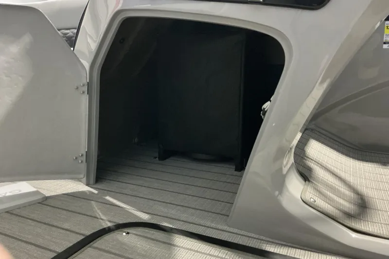Slide: The Image of Open storage compartment in 2026 Manitou Encore RF SHP575 230 boat interior. - 12
