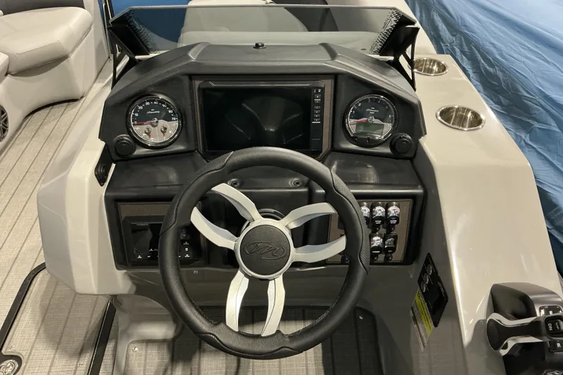Slide: The Image of Steering console of 2026 Manitou Encore RF SHP575 230 boat with gauges and controls. - 6