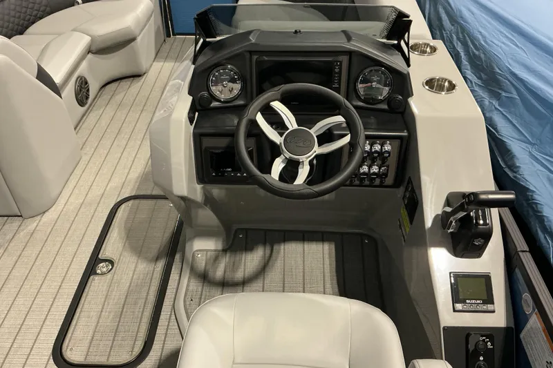 Slide: The Image of 2026 Manitou Encore RF SHP575 230 boat dashboard with steering wheel and controls. - 9