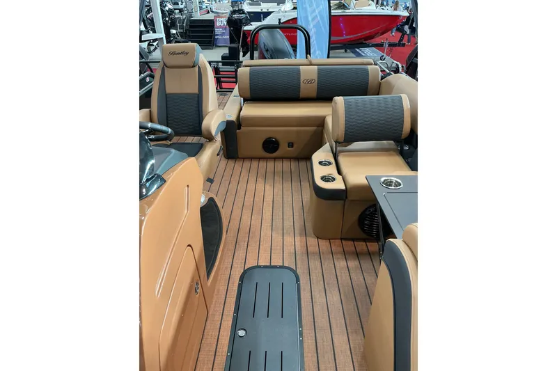 Slide: The Image of 2026 Bentley Pontoons Elite 223 interior with luxurious seating and wood-style flooring. - 7