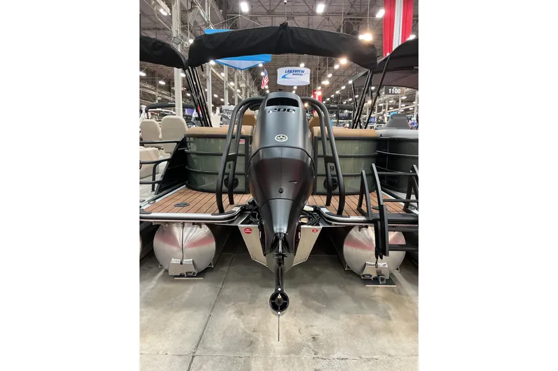 Slide: The Image of 2026 Bentley Pontoons Legacy 223 Navigator 3/4 Tube displayed at a boat show. - 2