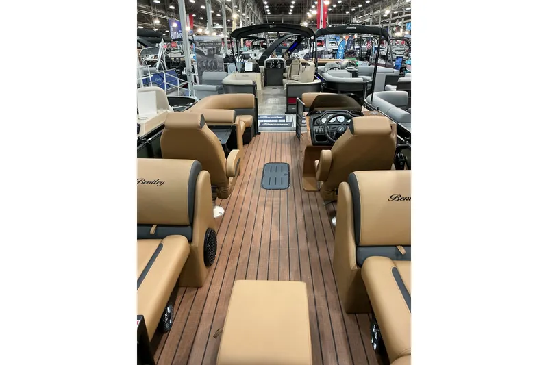 Slide: The Image of 2026 Bentley Pontoons Legacy 223 Navigator interior with luxurious seating and wood-style flooring. - 4