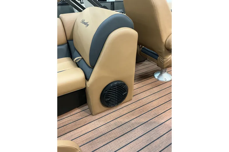 Slide: The Image of 2026 Bentley Pontoons Legacy 223 Navigator interior with tan seating and speaker detail. - 7