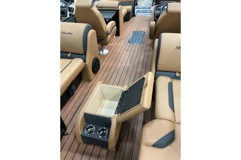 Slide: The Image of 2026 Bentley Pontoons Legacy 223 Navigator interior with tan seating and built-in cooler. - 8