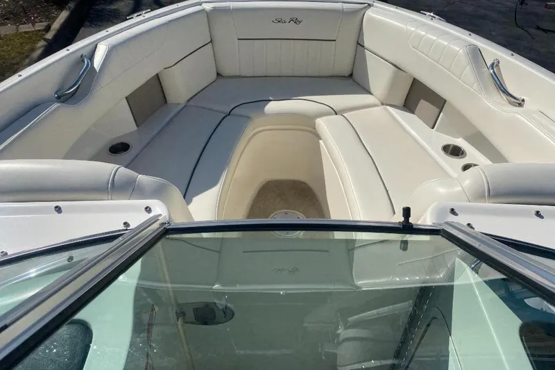 Slide: The Image of 2006 Sea Ray 270 SLX boat interior with white seating and cup holders. - 11