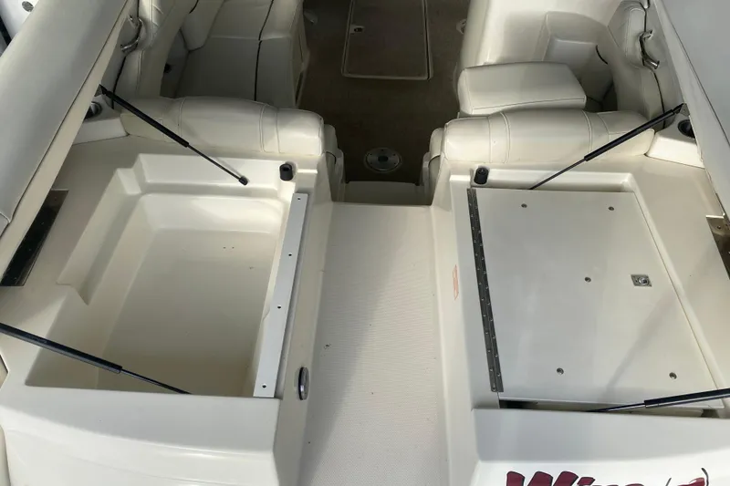 Slide: The Image of 2006 Sea Ray 270 SLX boat interior with open storage compartments and white seating. - 14