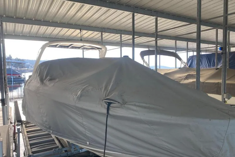 Slide: The Image of Covered 2006 Sea Ray 270 SLX boat in a sheltered dock area. - 16