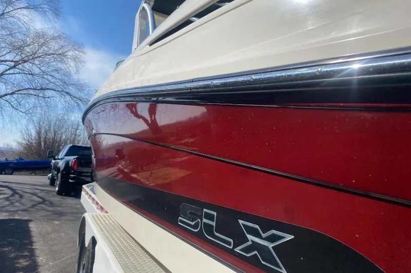 Slide: The Image of 2006 Sea Ray 270 SLX boat with red and white exterior on a trailer. - 4