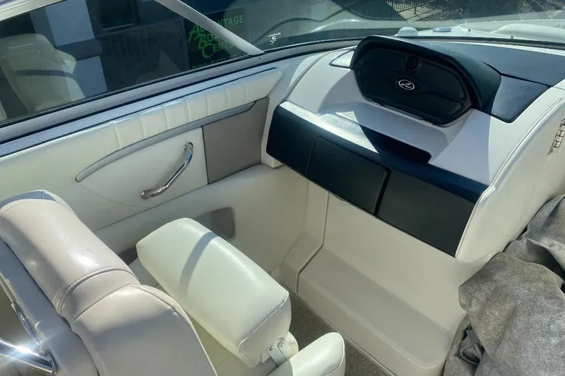 Slide: The Image of Interior of 2006 Sea Ray 270 SLX boat, featuring white leather seating and dashboard. - 8