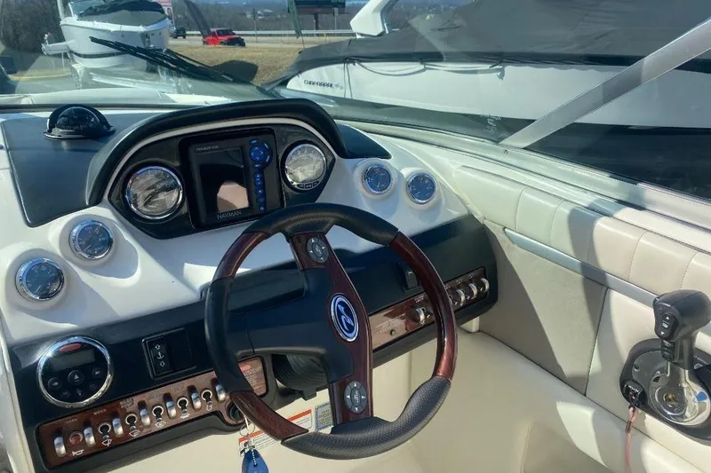 Slide: The Image of 2006 Sea Ray 270 SLX boat dashboard with steering wheel and navigation instruments. - 9