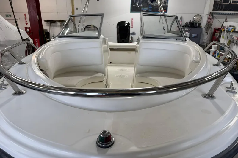 Slide: The Image of 2003 Boston Whaler 180 Ventura boat interior with white seating and stainless steel railings. - 4