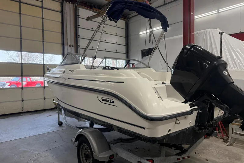 Slide: The Image of 2003 Boston Whaler 180 Ventura boat in garage, on trailer, with outboard motor. - 9