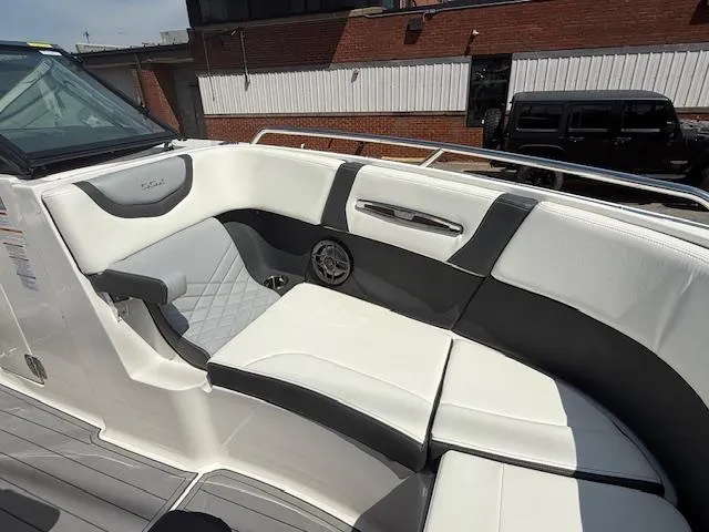 Slide: The Image of 2023 Chaparral 267 SSX boat interior with white and gray seating, modern design. - 10