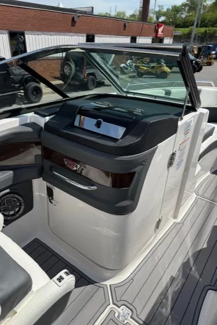 Slide: The Image of 2023 Chaparral 267 SSX boat interior with sleek dashboard and seating. - 16