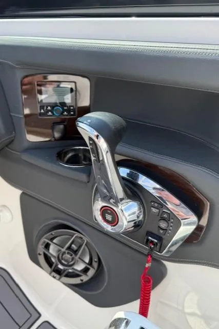 Slide: The Image of Control panel of 2023 Chaparral 267 SSX boat with throttle and speaker. - 21
