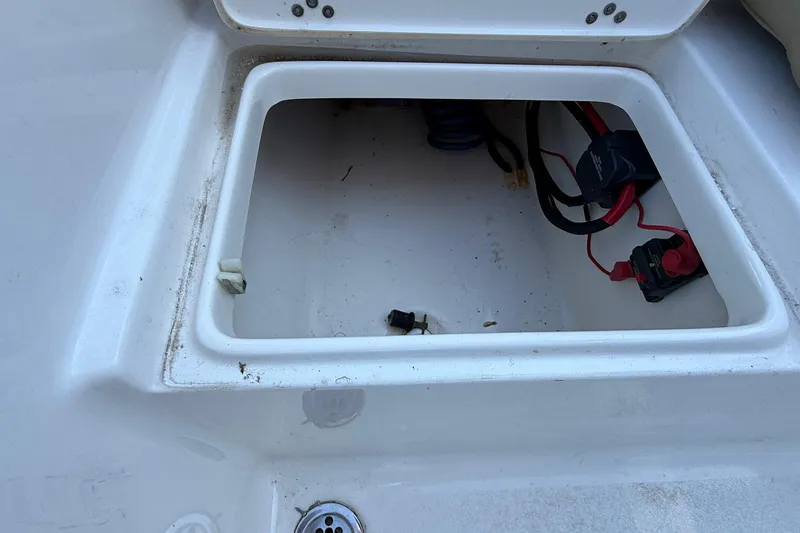 Slide: The Image of Open storage compartment on a 2017 Key West 189 FS boat, showing wiring and connections. - 19