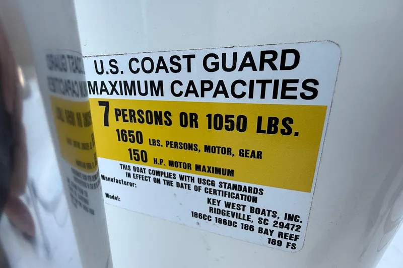 Slide: The Image of U.S. Coast Guard capacity label on 2017 Key West 189 FS boat, 7 persons or 1050 lbs. - 26