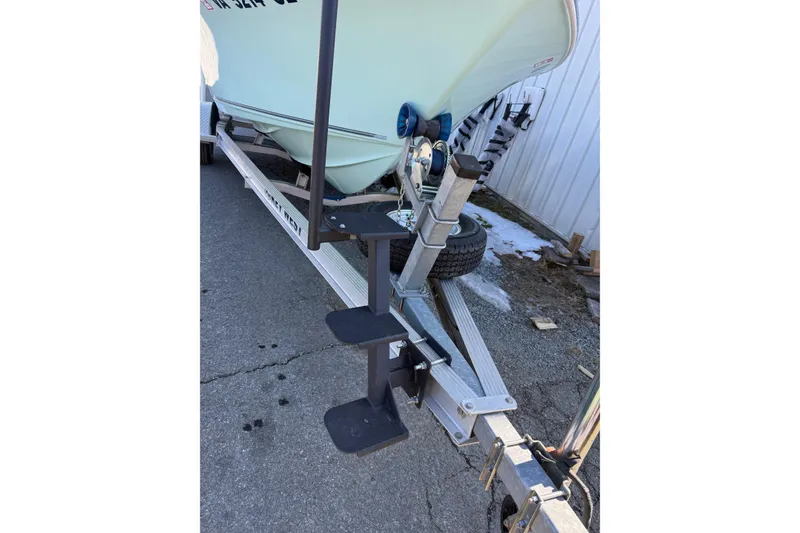 Slide: The Image of 2017 Key West 189 FS boat on trailer with steps, parked on pavement. - 31
