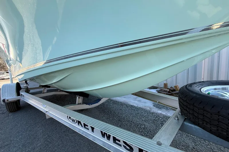 Slide: The Image of 2017 Key West 189 FS boat on trailer, close-up of hull and tire. - 32