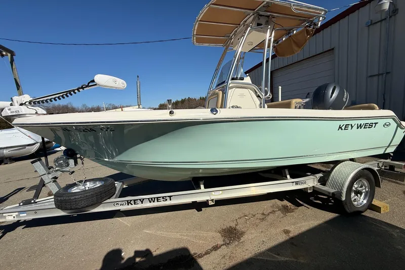 Slide: The Image of 2017 Key West 189 FS boat on trailer, light blue hull, parked outdoors. - 39