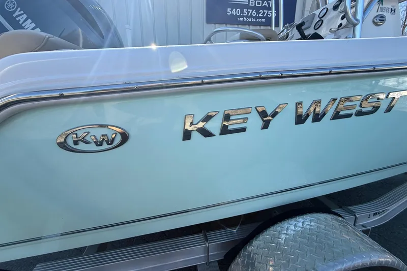 Slide: The Image of 2017 Key West 189 FS boat side view with logo and trailer. - 4