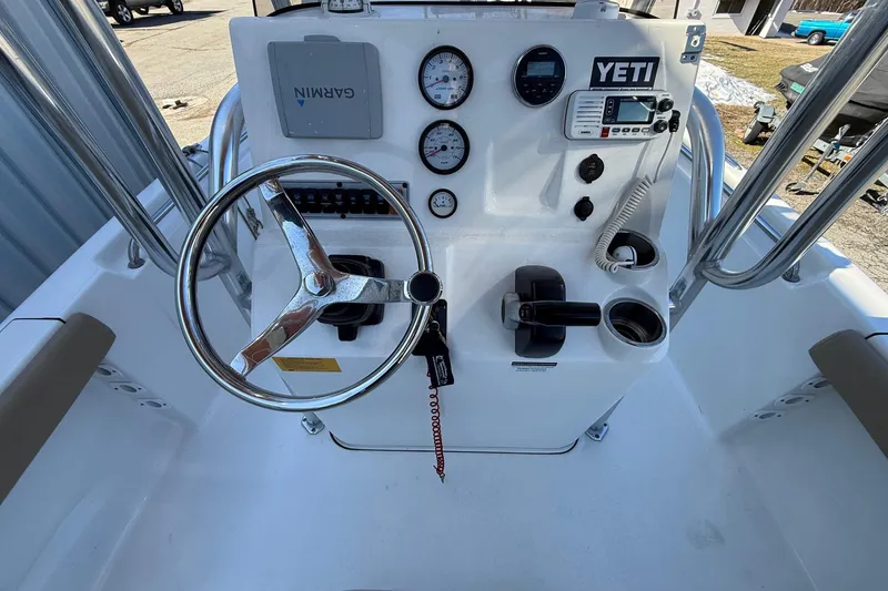 Slide: The Image of 2017 Key West 189 FS boat console with steering wheel, gauges, and controls. - 5