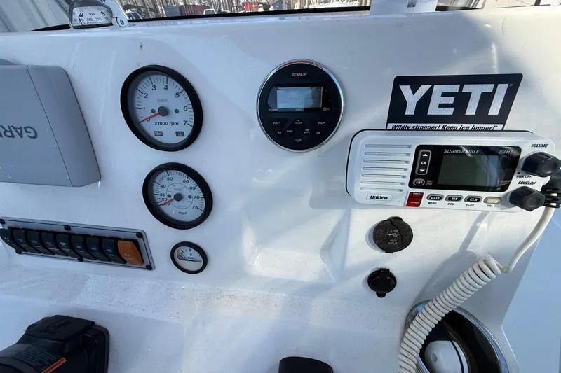Slide: The Image of Dashboard of 2017 Key West 189 FS boat with gauges, radio, and Yeti sticker. - 6