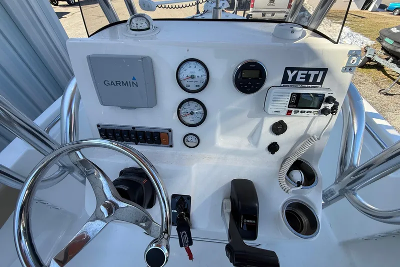 Slide: The Image of 2017 Key West 189 FS boat dashboard with Garmin, Yeti sticker, and Yamaha controls. - 8