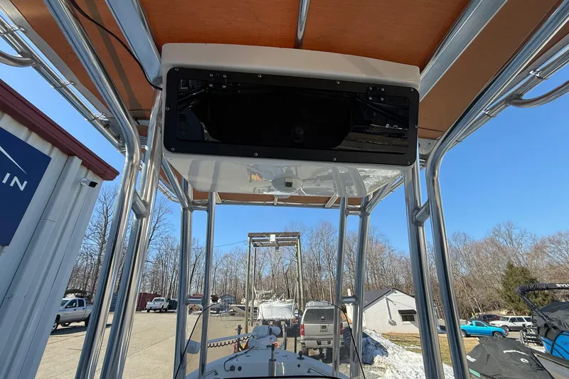 Slide: The Image of 2017 Key West 189 FS boat with T-top and electronics box, parked outdoors. - 9