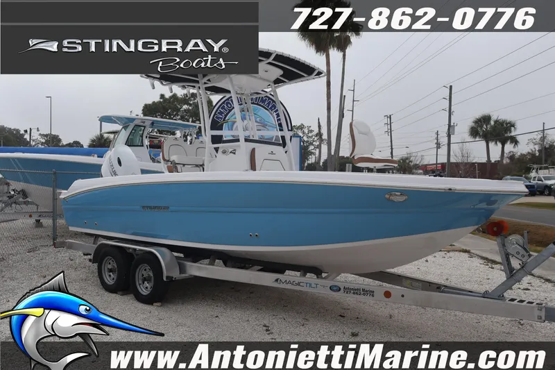 The Image of 2026 Stingray 236 CC boat on trailer at Antonietti Marine dealership. - 1