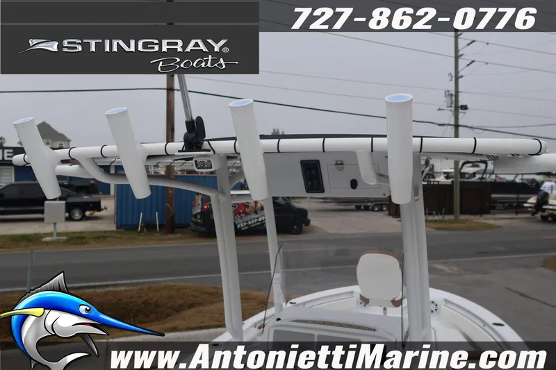 Slide: The Image of 2026 Stingray 236 CC boat with rod holders, displayed at Antonietti Marine. - 12