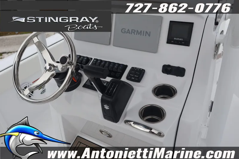 Slide: The Image of 2026 Stingray 236 CC boat dashboard with Garmin system and Suzuki controls. - 13