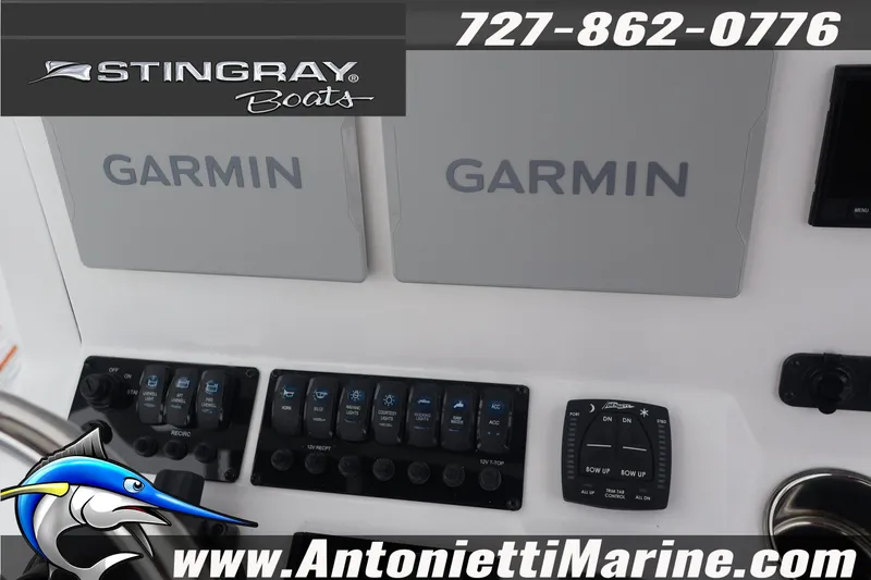 Slide: The Image of 2026 Stingray 236 CC boat dashboard with Garmin navigation and control panels. - 14