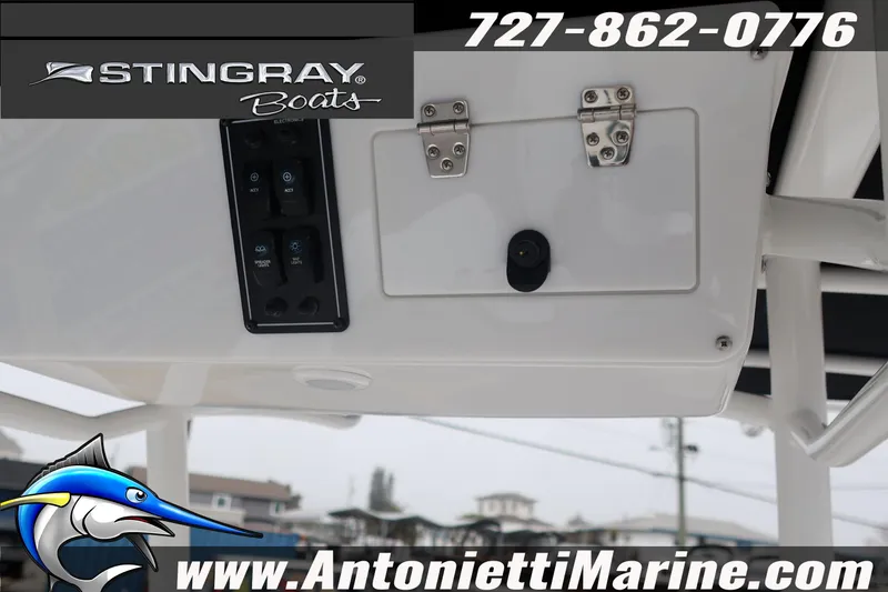 Slide: The Image of 2026 Stingray 236 CC boat console with control panel and storage compartment. - 19