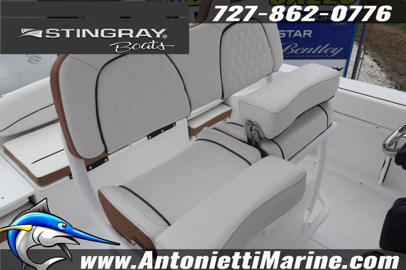 Slide: The Image of 2026 Stingray 236 CC boat interior with white seating, displayed by Antonietti Marine. - 21