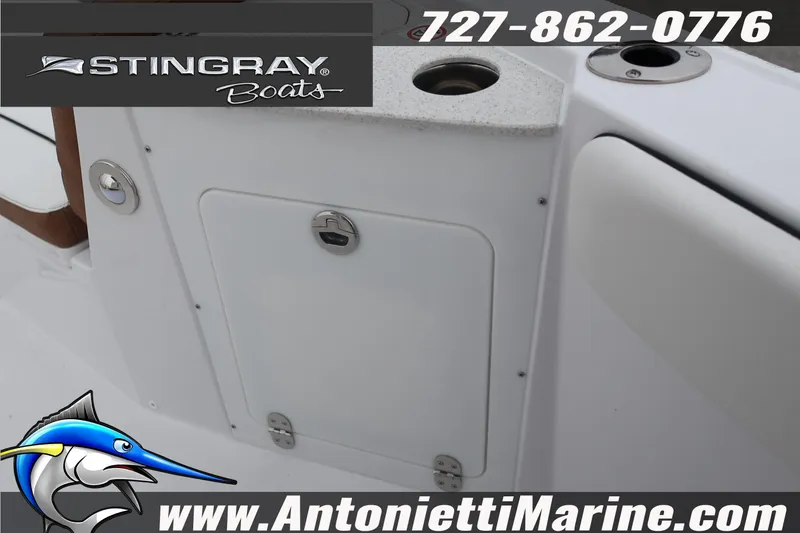Slide: The Image of 2026 Stingray 236 CC boat interior with storage compartment and contact details. - 23