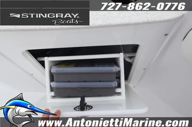 Slide: The Image of 2026 Stingray 236 CC boat storage compartment with tackle boxes, Antonietti Marine branding. - 24