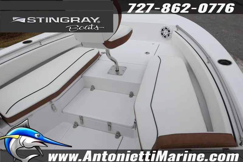 Slide: The Image of 2026 Stingray 236 CC boat interior with white seating and brown accents. - 26